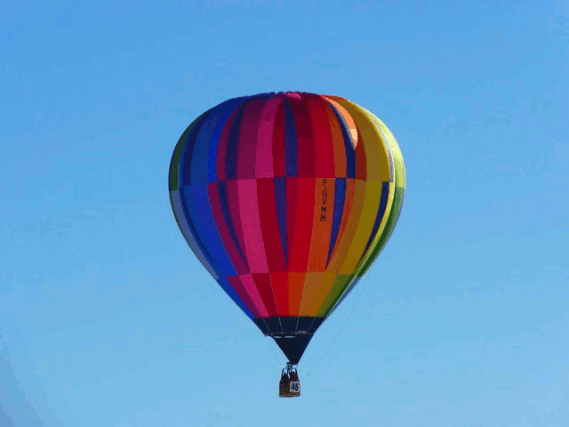 In this example, we remove the background from a BMP image of a hot air balloon. We target the bluish color of the sky and select the visually closest color with the color picker. The picker automatically enters the selected color in the color-to-match field (in RGB format). Since the color of the sky changes from light blue to blue, we increase the fuzziness threshold to 10% to match all these color tones in the background gradient.