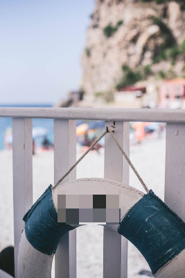 In this example, we pixelate the writing on a beach life ring to hide the name of the beach location while keeping the photo itself easy to recognize. We use a rectangular pixelation region at position (84, 274), set its size to 89 by 48 pixels, and apply 20-pixel blocks. This covers the LIDO lettering with a compact mosaic while leaving the railing, sea view, cliffs, and life ring shape unchanged. (Source: Pexels.)