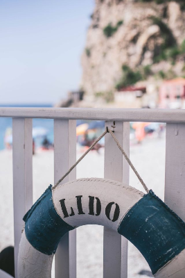 In this example, we pixelate the writing on a beach life ring to hide the name of the beach location while keeping the photo itself easy to recognize. We use a rectangular pixelation region at position (84, 274), set its size to 89 by 48 pixels, and apply 20-pixel blocks. This covers the LIDO lettering with a compact mosaic while leaving the railing, sea view, cliffs, and life ring shape unchanged. (Source: Pexels.)