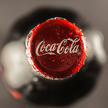 In this example, we place a circular sharpening area over a Coca-Cola bottle cap and increase the sharpness to 100%. This makes the cap much clearer as the main focus of the bitmap: the water droplets gain a crisp, bead-like structure, the red metal edge becomes better defined, and the white logo stands out more cleanly against the glossy surface. (Source: Pexels.)