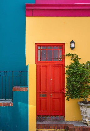 In this example, we create a compact four-color palette from a BMP photo of a bright building facade. The turquoise wall, sandy yellow facade, and red door occupy similar portions of the image at about 28%, 27%, and 25%, respectively. Dark brown details appear a little less often at nearly 19%. The palette makes this balance easy to compare by printing each RGB value beside its percentage. (Source: Pexels.)