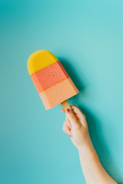 In this example, we correct the orientation of a BMP photo of a colorful ice cream held in a hand. We enter -25 degrees, and the negative angle rotates the image clockwise until the ice cream points straight up. The turn creates four empty corners around the tilted photo, which we fill with the default white background. (Source: Pexels.)