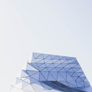 This example removes a large area of empty sky above a geometric building. We cut 150 pixels from the top of the BMP and leave the left, right, and bottom sides unchanged. This turns the 300-by-450-pixel portrait image into a compact 300-by-300-pixel square. (Source: Pexels.)