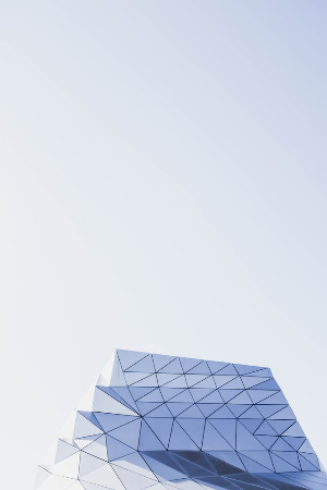 This example removes a large area of empty sky above a geometric building. We cut 150 pixels from the top of the BMP and leave the left, right, and bottom sides unchanged. This turns the 300-by-450-pixel portrait image into a compact 300-by-300-pixel square. (Source: Pexels.)