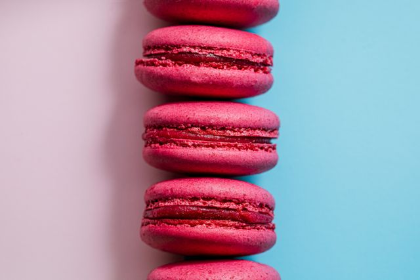 In this example, we horizontally flip a BMP image of pink macarons arranged in a vertical line. The pink and blue background areas switch places: the blue half moves from the left to the right, and the pink half moves from the right to the left. As the horizontal flip mirrors the bitmap across its vertical axis, the stack of macarons positioned on this axis remains centered between the two colors. (Source: Pexels.)