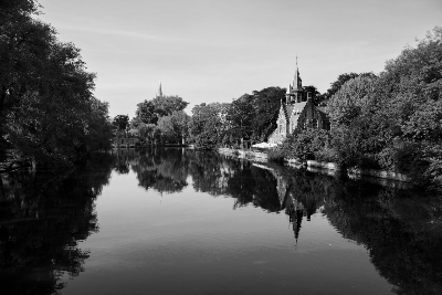In this example, we convert a bitmap photo of a calm historic canal to grayscale using the average RGB formula. This method gives equal importance to the red, green, and blue channels, so the bright sky, leafy trees, brick building, and dark water reflection are all reduced to a smooth and neutral gray range. (Source: Pexels.)