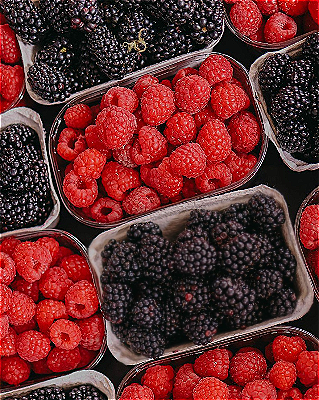 In this example, we use inverted sharpening on a bitmap with trays of raspberries and blackberries. We select one rectangular blackberry tray, rotate the selected area by 16 degrees counterclockwise to match the tray's angle, and then sharpen everything around that selected tray. As a result, the other raspberry and blackberry trays become clearer while the chosen tray stays unchanged. We use a mild 60% sharpness setting to gently emphasize the natural berry details. (Source: Pexels.)