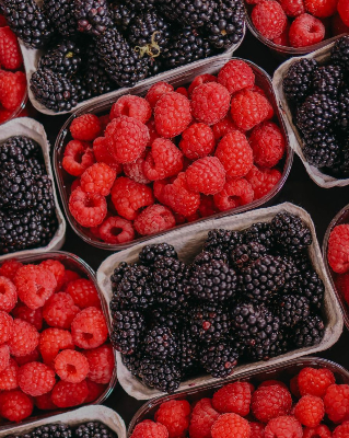In this example, we use inverted sharpening on a bitmap with trays of raspberries and blackberries. We select one rectangular blackberry tray, rotate the selected area by 16 degrees counterclockwise to match the tray's angle, and then sharpen everything around that selected tray. As a result, the other raspberry and blackberry trays become clearer while the chosen tray stays unchanged. We use a mild 60% sharpness setting to gently emphasize the natural berry details. (Source: Pexels.)