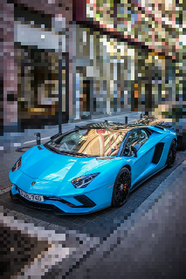 In this example, we use inverted pixelation to hide the shooting location in a street photo. The bright blue sports car is the stylish subject we want to show, but because the photo was taken near home, the storefronts, sidewalk, and street details around it should be harder to identify. We place an oval region around the car, rotate it by 15 degrees, and enable the outside-region mode. With a 5-pixel block size, the car stays sharp while the surrounding location turns into a pixelated mosaic. (Source: Pexels.)