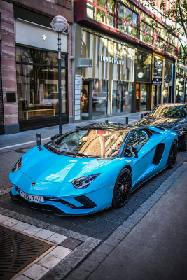 In this example, we use inverted pixelation to hide the shooting location in a street photo. The bright blue sports car is the stylish subject we want to show, but because the photo was taken near home, the storefronts, sidewalk, and street details around it should be harder to identify. We place an oval region around the car, rotate it by 15 degrees, and enable the outside-region mode. With a 5-pixel block size, the car stays sharp while the surrounding location turns into a pixelated mosaic. (Source: Pexels.)